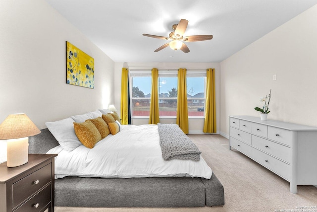 bedroom with light colored carpet and ceiling fan