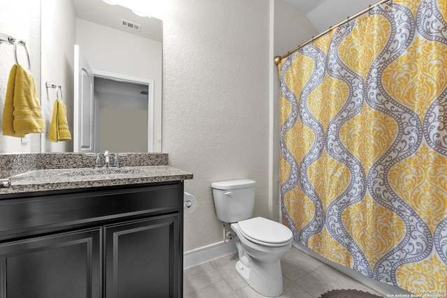 bathroom with vanity, toilet, and tile patterned flooring