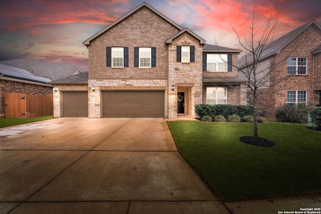 view of front facade with a garage and a yard