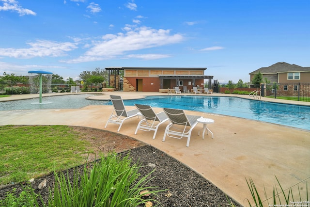 view of pool featuring pool water feature and a patio area