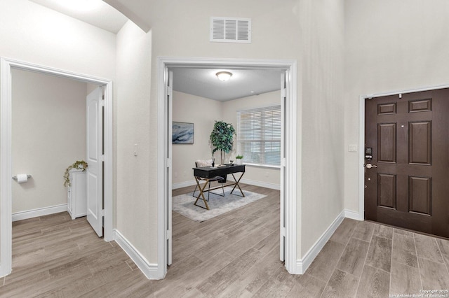 foyer with light hardwood / wood-style floors