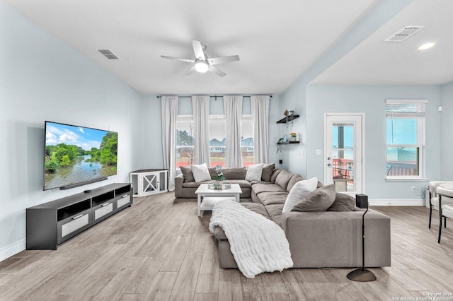 living room with ceiling fan and light hardwood / wood-style flooring