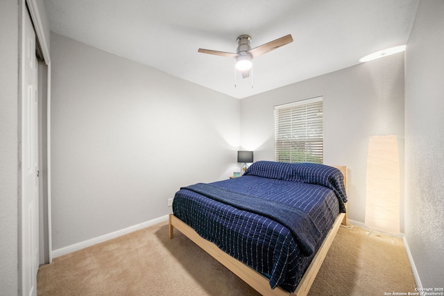 bedroom with light carpet and ceiling fan