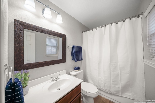 bathroom featuring a shower with curtain, vanity, and toilet