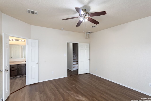 unfurnished bedroom featuring ceiling fan, a textured ceiling, and dark hardwood / wood-style flooring