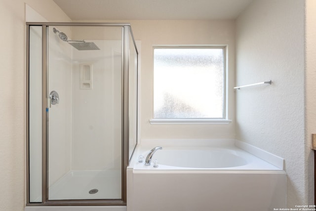 bathroom featuring separate shower and tub