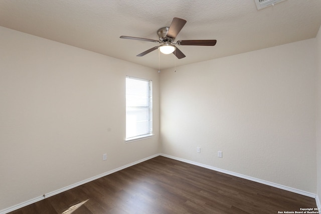 spare room with ceiling fan, a textured ceiling, and dark hardwood / wood-style flooring