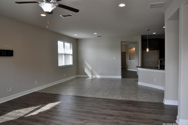 spare room featuring ceiling fan, sink, and dark hardwood / wood-style flooring