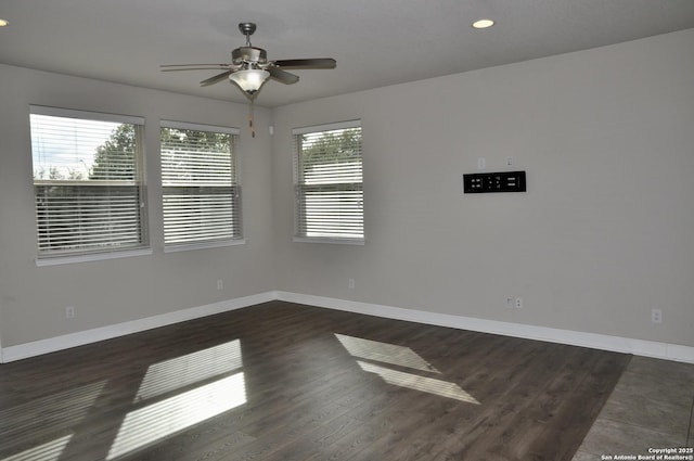 empty room featuring dark hardwood / wood-style floors and ceiling fan