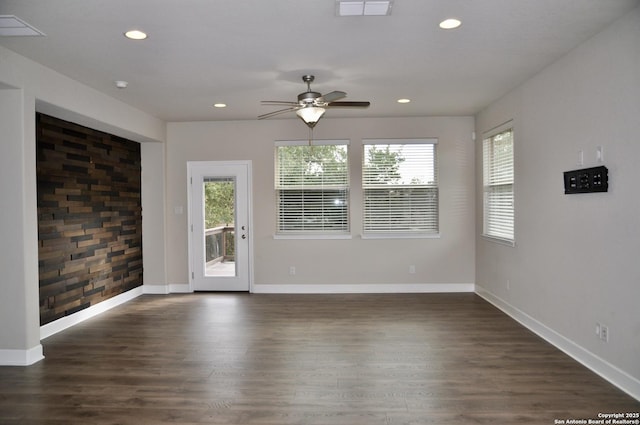 empty room with dark hardwood / wood-style floors and ceiling fan