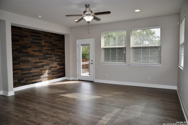 unfurnished room featuring ceiling fan and dark hardwood / wood-style floors