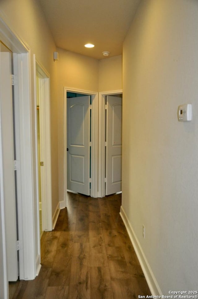 corridor with dark wood-type flooring