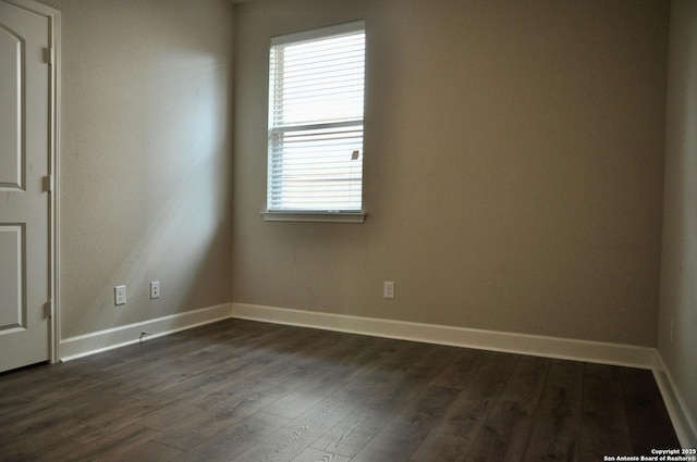 empty room featuring dark wood-type flooring