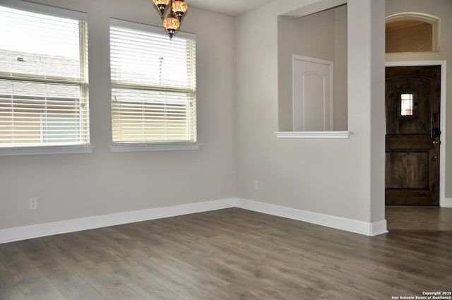 spare room featuring dark wood-type flooring