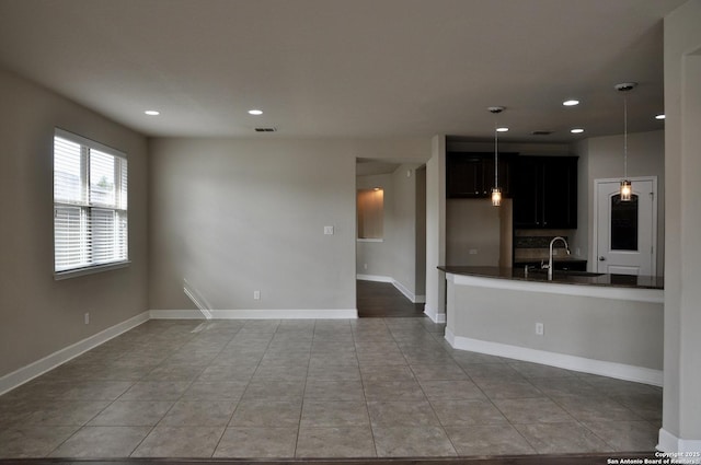 interior space with light tile patterned flooring and sink