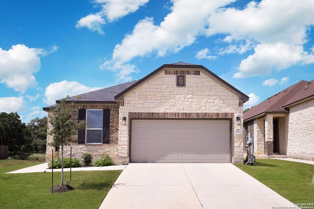 craftsman-style house featuring a garage and a front yard