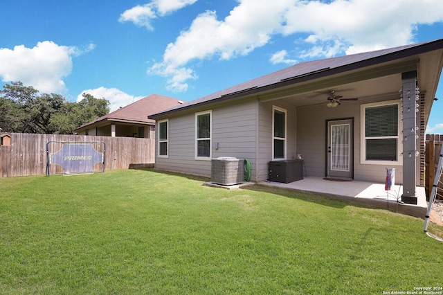 back of house with a yard, central AC unit, ceiling fan, and a patio area