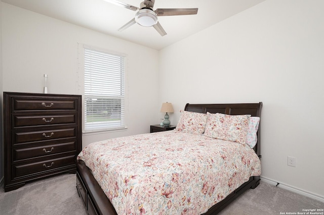 bedroom with ceiling fan and light carpet