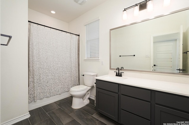 full bathroom with vanity, shower / bath combination with curtain, and toilet