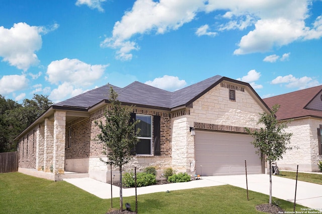 view of front of home with a garage and a front lawn