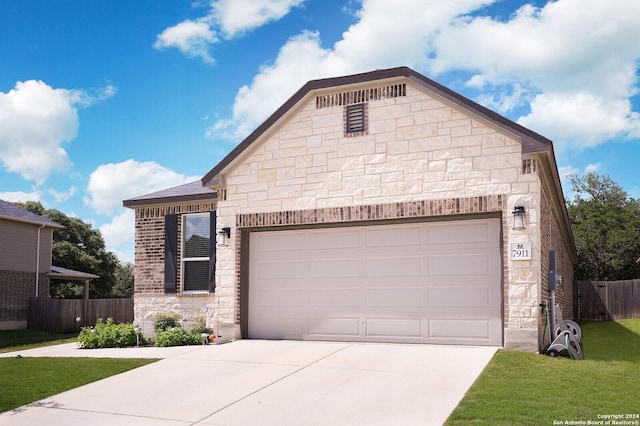 view of front facade with a garage and a front yard