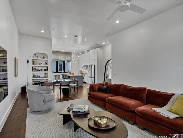 living room featuring ceiling fan and light wood-type flooring