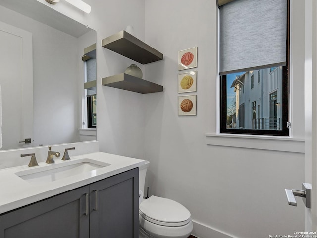 bathroom featuring vanity and toilet