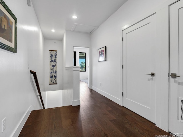 corridor with dark hardwood / wood-style flooring