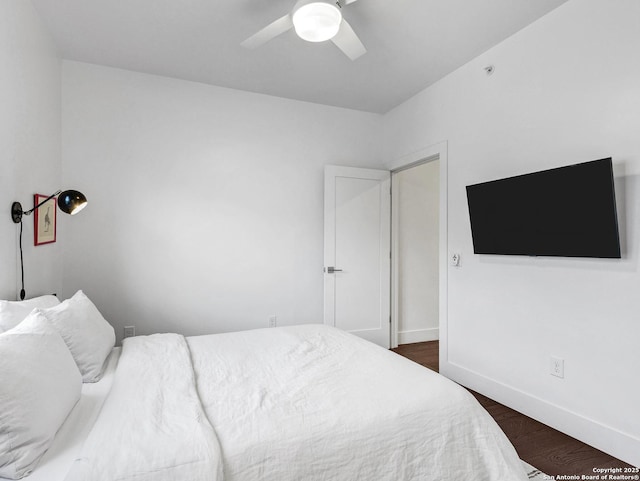 bedroom with dark hardwood / wood-style flooring and ceiling fan