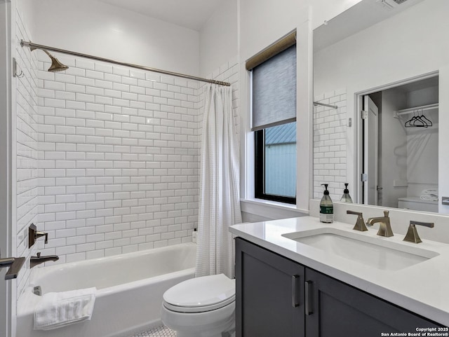 full bathroom featuring vanity, shower / bath combination with curtain, and toilet