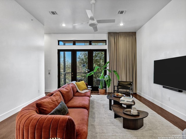 living room with hardwood / wood-style flooring, ceiling fan, and french doors