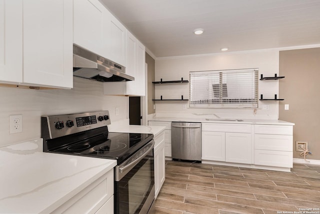 kitchen with sink, stainless steel appliances, light stone countertops, white cabinets, and decorative backsplash