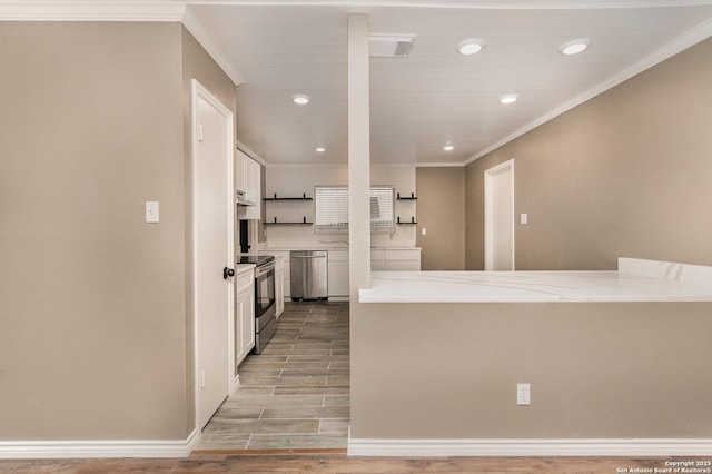 kitchen featuring stainless steel appliances, crown molding, white cabinets, and light wood-type flooring