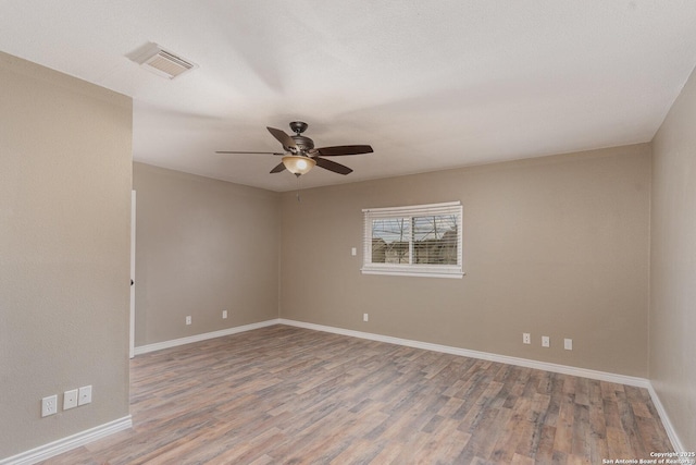 empty room with hardwood / wood-style flooring and ceiling fan