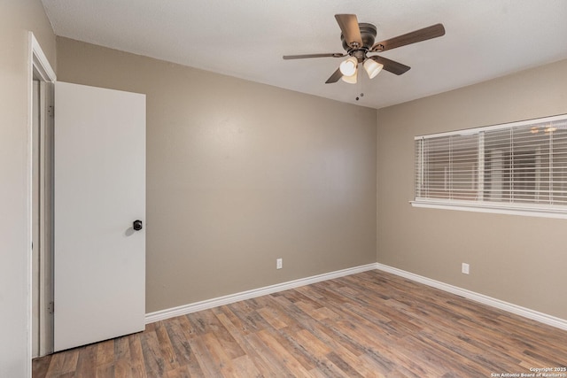 spare room featuring hardwood / wood-style floors and ceiling fan