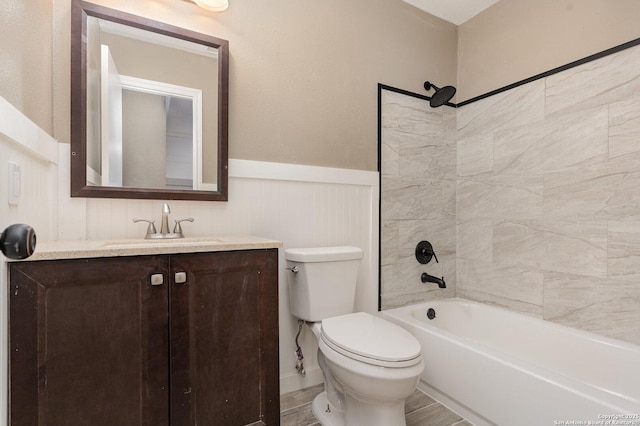 full bathroom featuring tiled shower / bath combo, vanity, and toilet