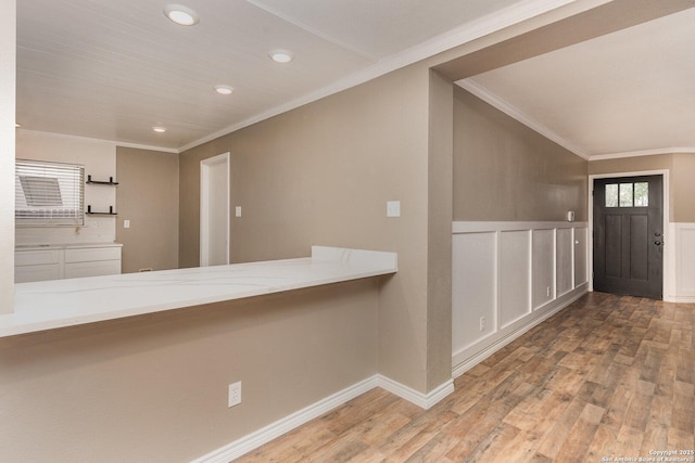 foyer with crown molding and wood-type flooring