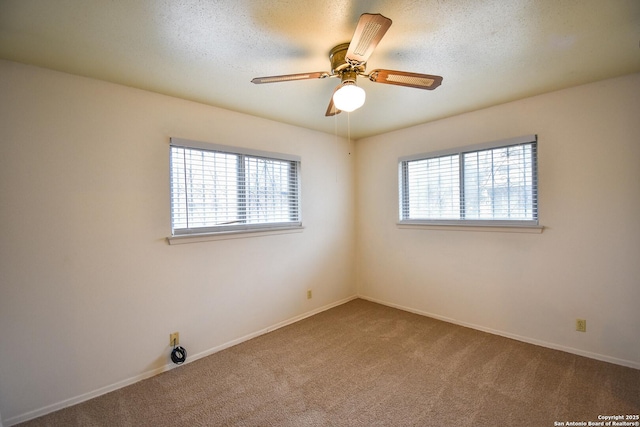 spare room with ceiling fan, carpet flooring, and a textured ceiling