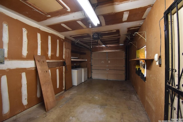 garage with a garage door opener and washer and clothes dryer