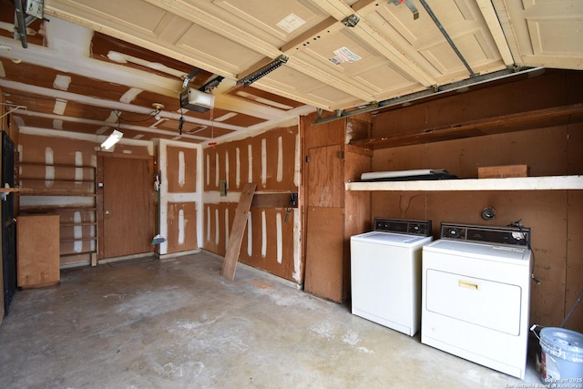 garage with a garage door opener and washing machine and dryer