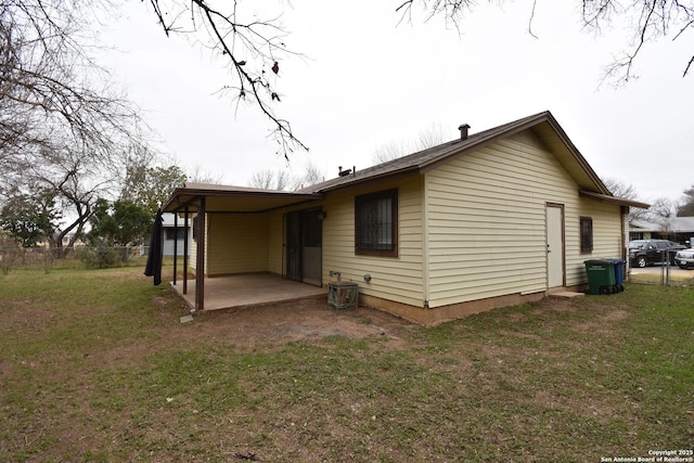 view of side of property with a patio and a yard