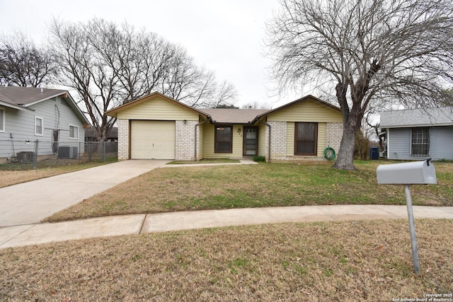 ranch-style home with a garage, a front yard, and central AC unit