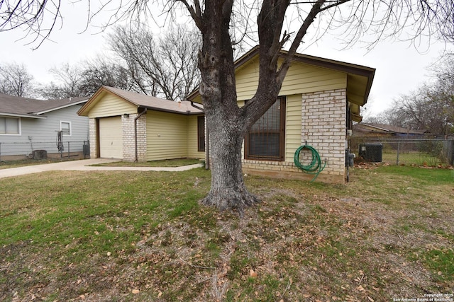 view of front of house featuring central AC unit, a garage, an outdoor structure, and a front lawn