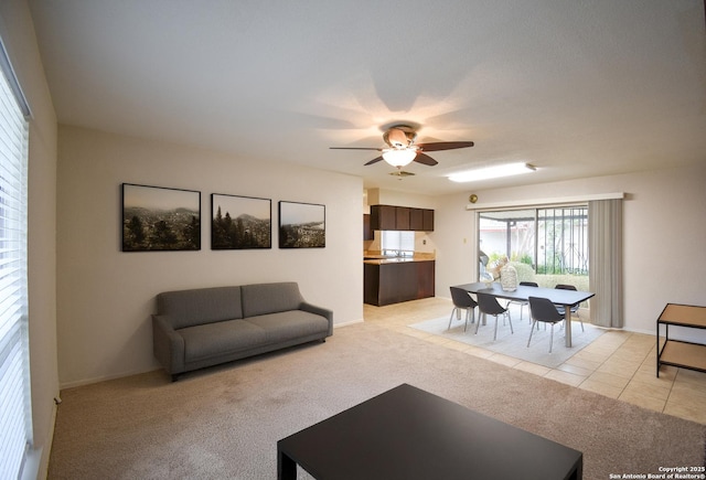 carpeted living room with ceiling fan