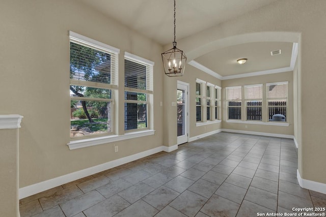 tiled spare room with a notable chandelier and a healthy amount of sunlight