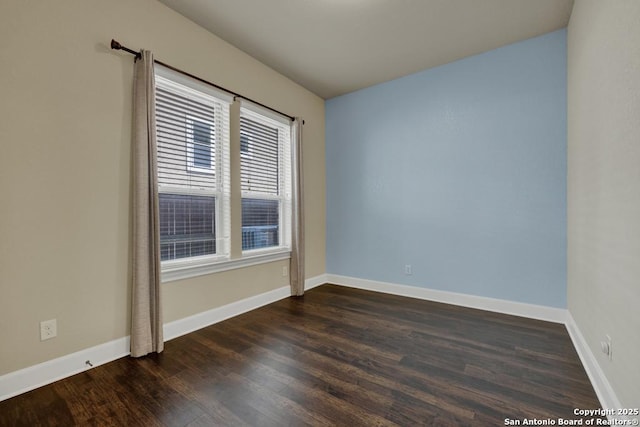 empty room with dark hardwood / wood-style flooring