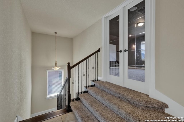 stairway featuring french doors