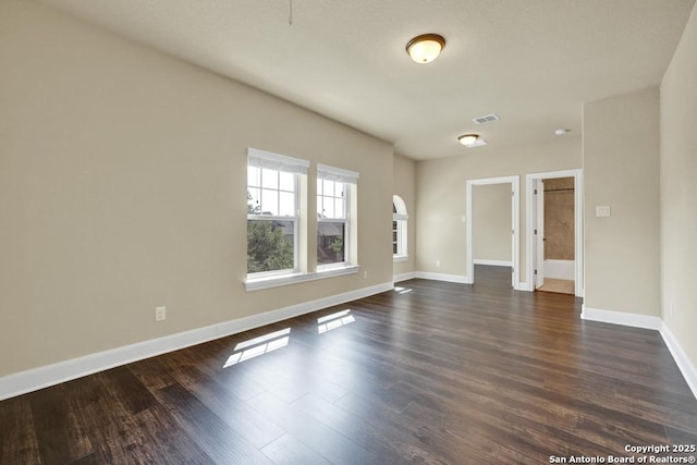 unfurnished room featuring dark wood-type flooring