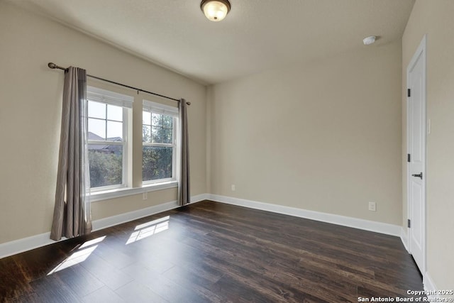 unfurnished room featuring dark hardwood / wood-style floors