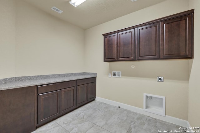 washroom featuring cabinets, hookup for an electric dryer, hookup for a gas dryer, and hookup for a washing machine